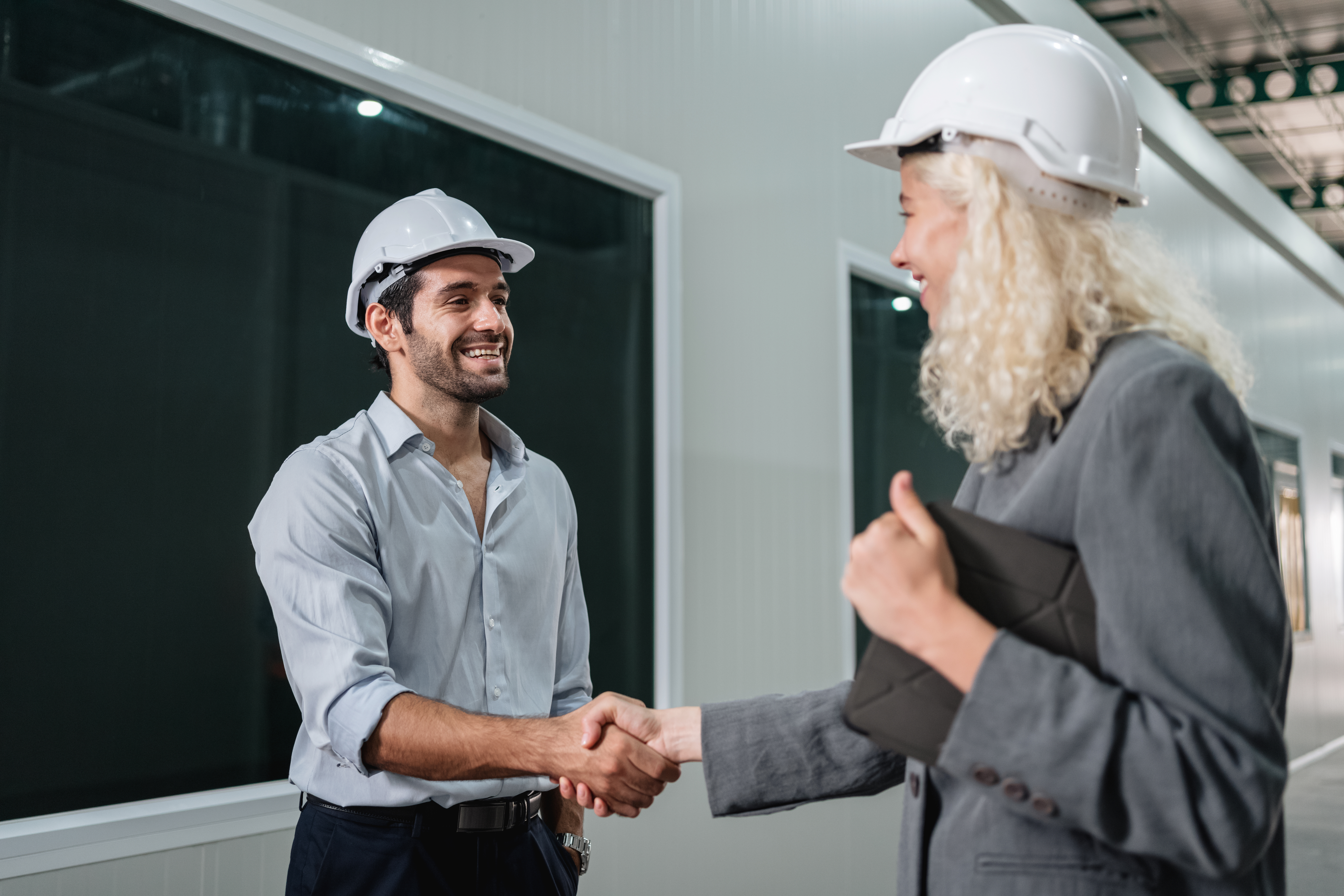 Team engineers and foreman stack hand and shake hands to show success at factory machines. Worker industry join hand for collaboration.